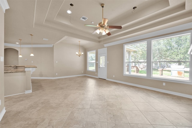 unfurnished living room with sink, a raised ceiling, light tile patterned floors, and ceiling fan with notable chandelier