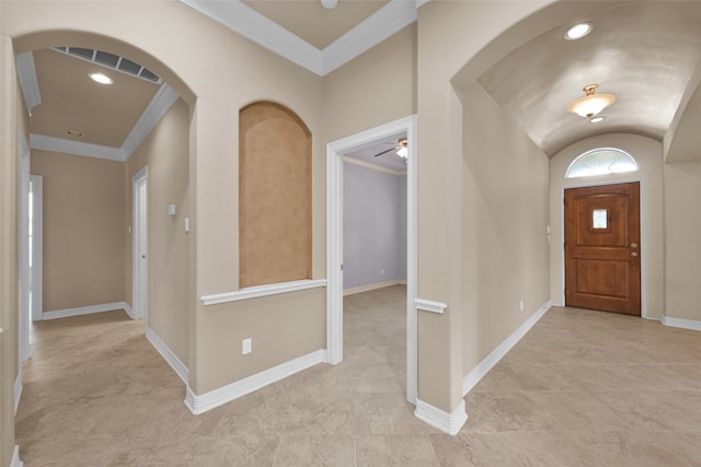 entrance foyer featuring ornamental molding, vaulted ceiling, and ceiling fan