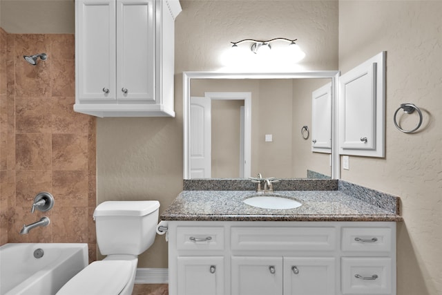 full bathroom featuring vanity, tiled shower / bath combo, and toilet