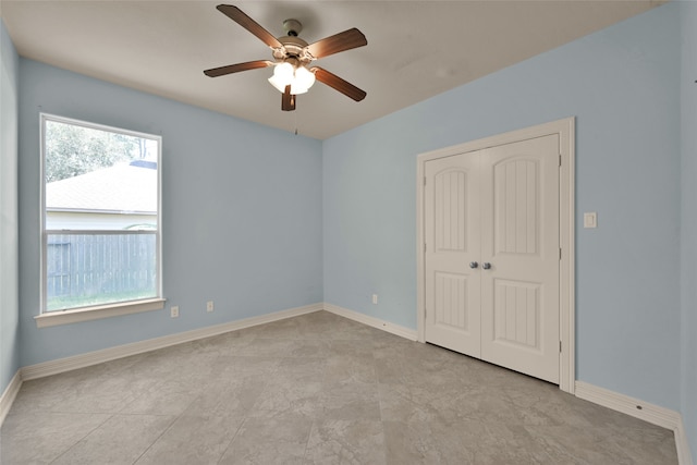 unfurnished bedroom featuring a closet, ceiling fan, and light tile patterned flooring