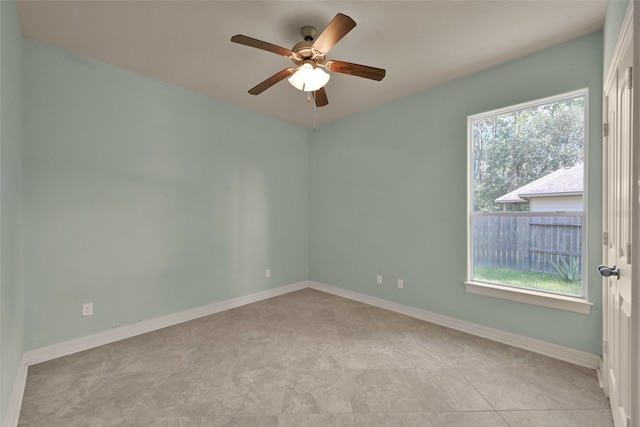 unfurnished room featuring a wealth of natural light and ceiling fan