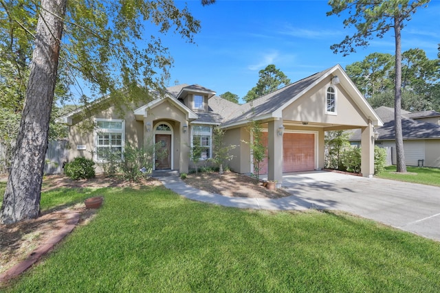 view of front of property with a front yard and a garage