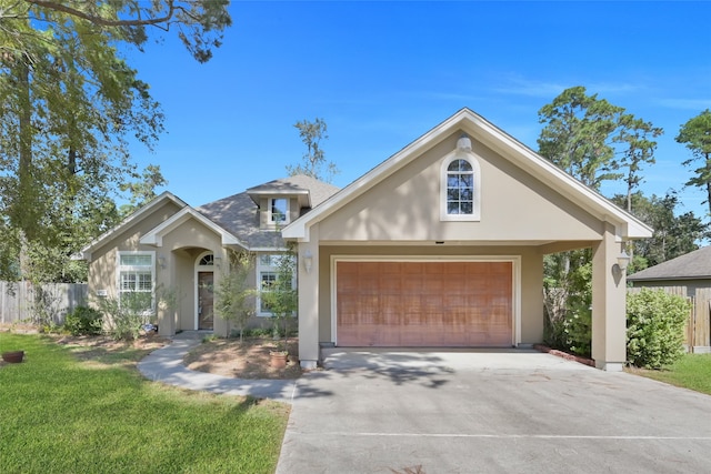 view of front of property with a garage and a front lawn