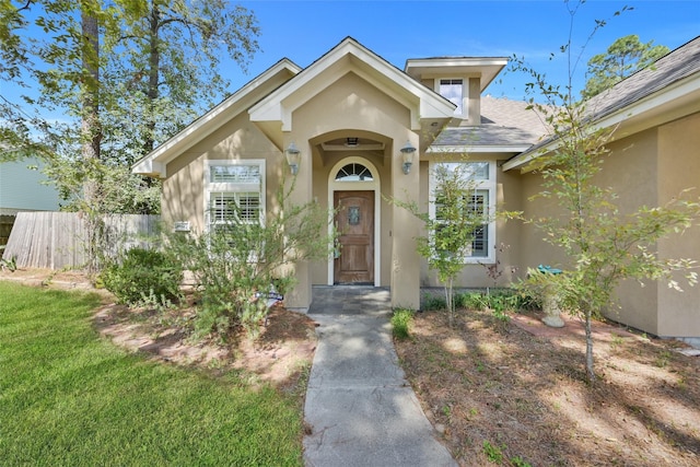 doorway to property featuring a yard