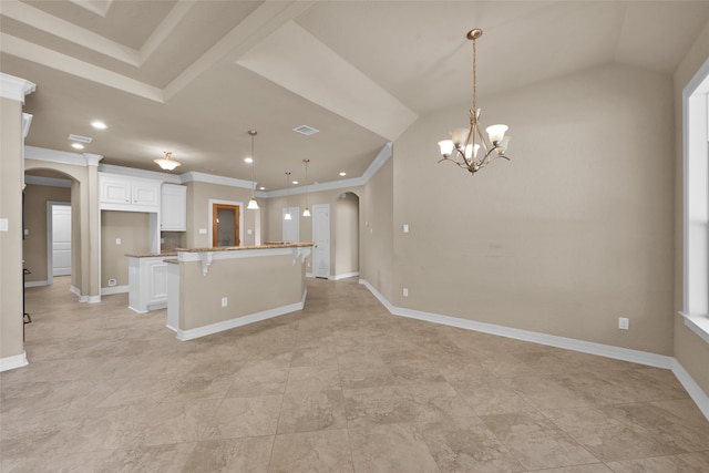 kitchen with a breakfast bar area, white cabinets, a center island, and pendant lighting