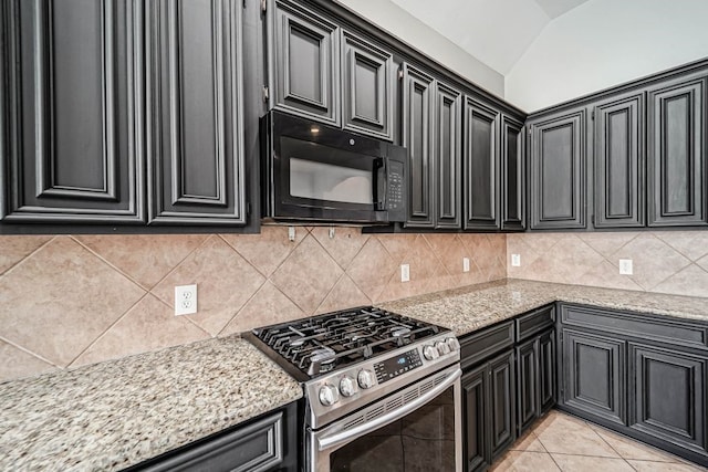 kitchen featuring light tile flooring, light stone countertops, tasteful backsplash, and stainless steel range with gas stovetop