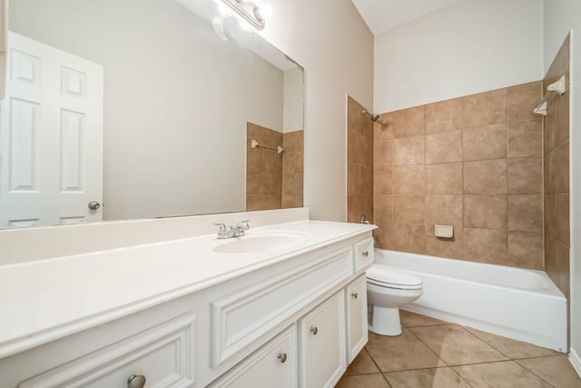 full bathroom with tile flooring, oversized vanity, toilet, and tiled shower / bath