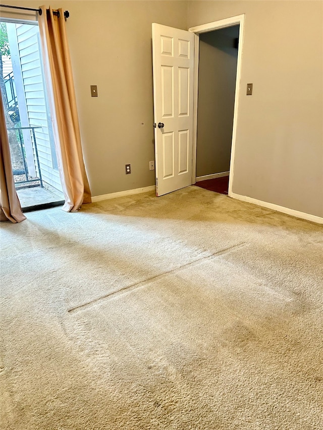 empty room featuring light carpet