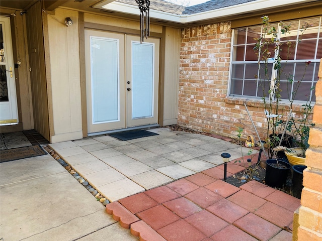 property entrance featuring a patio and french doors