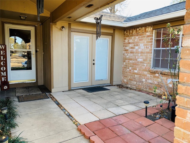 view of exterior entry featuring a patio