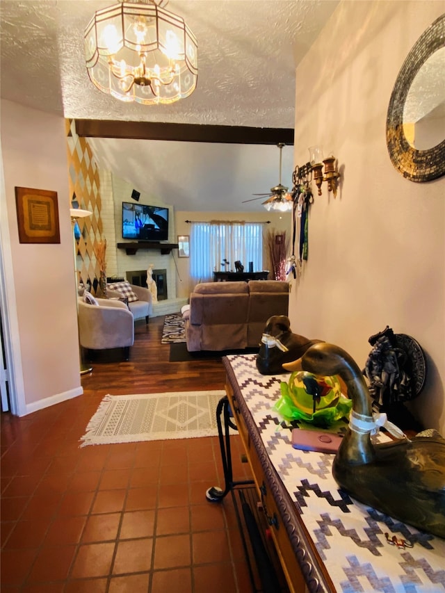 interior space with a chandelier, a textured ceiling, and dark tile flooring