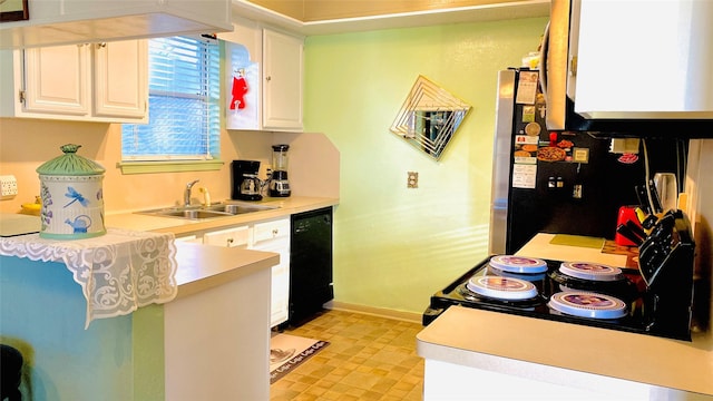 kitchen featuring white cabinetry, sink, and black appliances