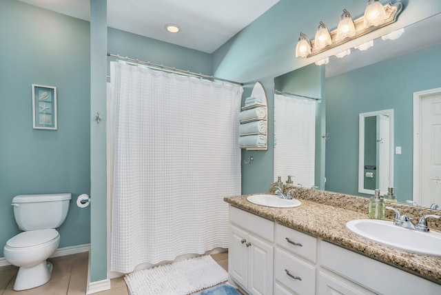 bathroom featuring dual bowl vanity, tile flooring, and toilet