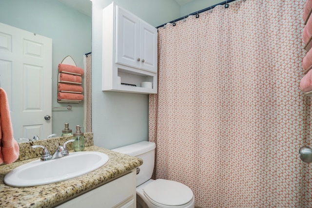 bathroom featuring toilet and vanity