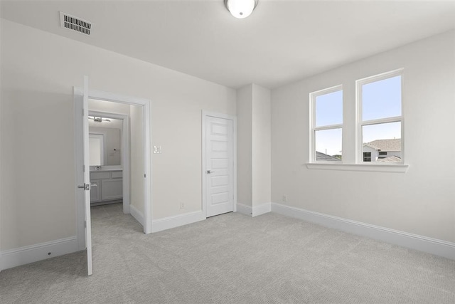 unfurnished bedroom featuring light carpet