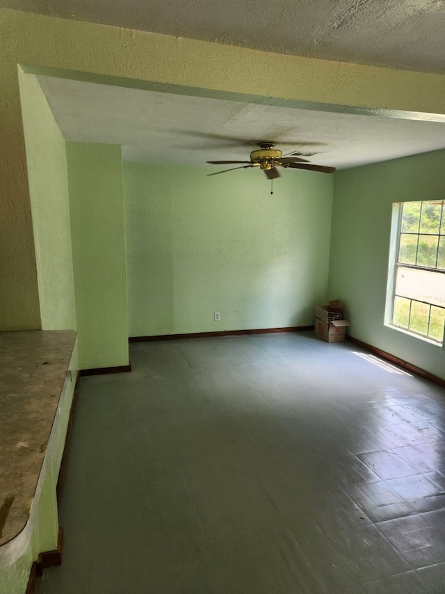 spare room featuring ceiling fan and a textured ceiling