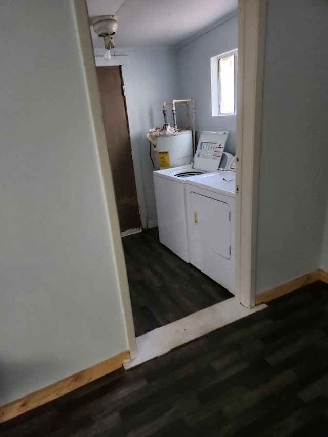 washroom featuring dark hardwood / wood-style flooring, washer and clothes dryer, and water heater