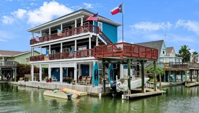 rear view of house with a balcony and a water view