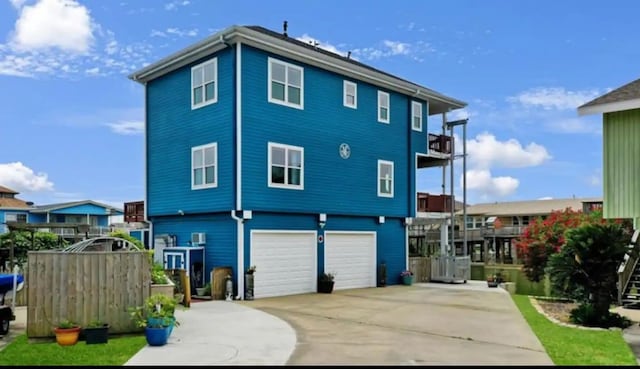 view of front of home with central AC unit and a garage