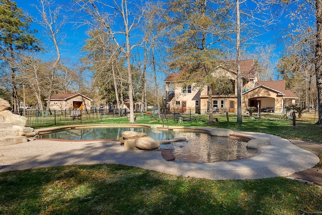 view of pool with a yard