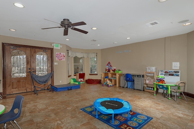 recreation room featuring french doors, a wealth of natural light, and ceiling fan