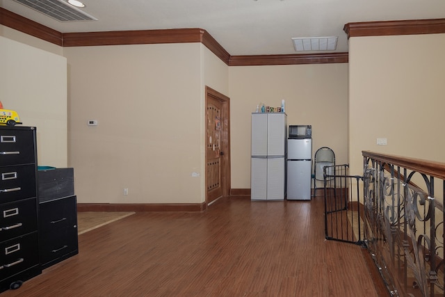 interior space featuring ornamental molding and dark hardwood / wood-style flooring