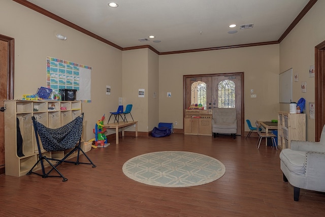 foyer with crown molding and dark hardwood / wood-style floors