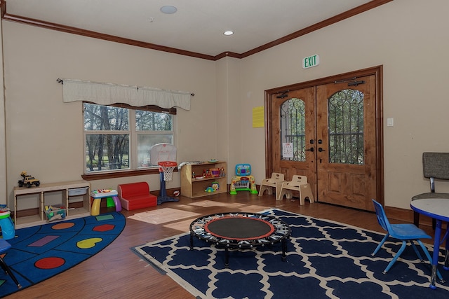 game room with french doors, crown molding, and hardwood / wood-style floors