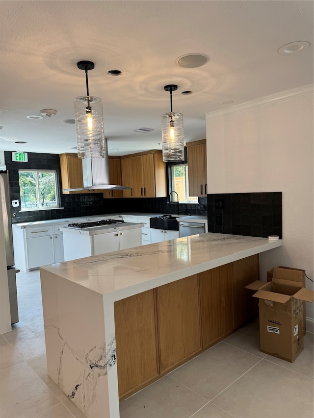 kitchen featuring pendant lighting, plenty of natural light, and white cabinets