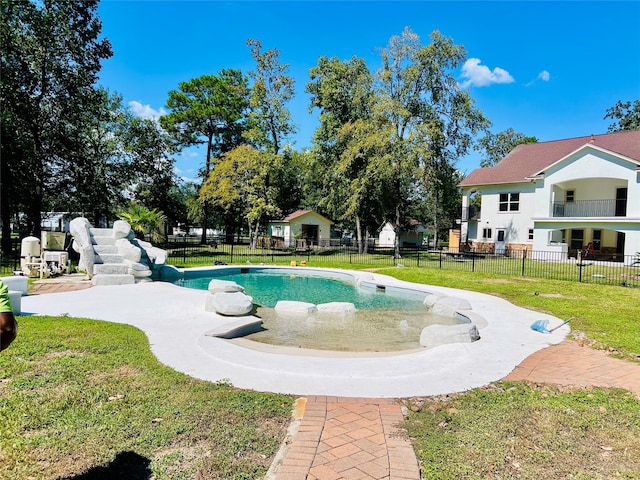 view of swimming pool with a lawn and a patio area