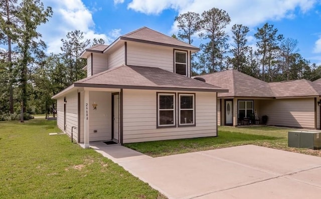 rear view of property featuring a lawn