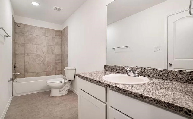 full bathroom featuring oversized vanity, toilet, tile flooring, and tiled shower / bath combo