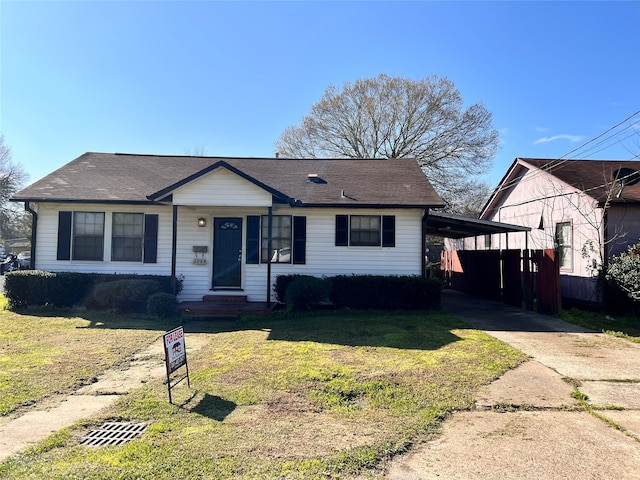 view of front facade with a carport and a front yard