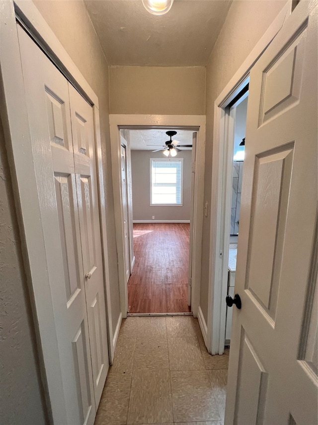 corridor featuring light tile floors