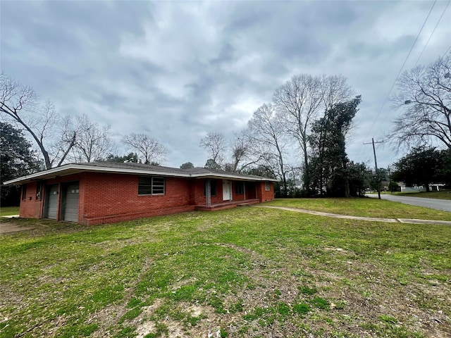 single story home with a front lawn and a garage