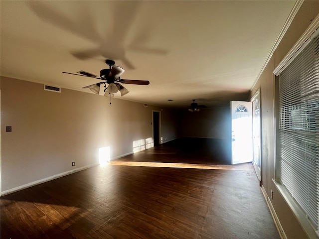 spare room featuring ceiling fan and dark wood-type flooring