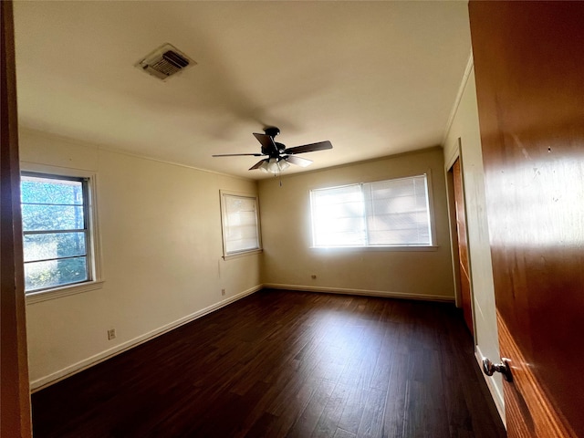 unfurnished room with dark hardwood / wood-style floors and ceiling fan