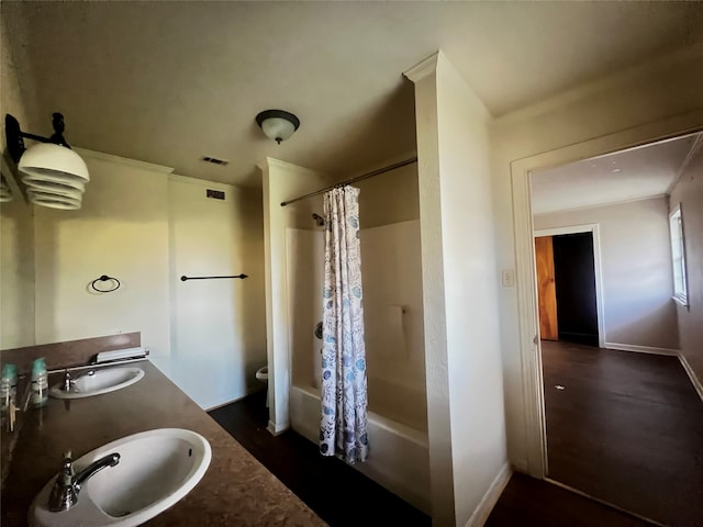 full bathroom featuring shower / bath combo, toilet, double sink, and large vanity