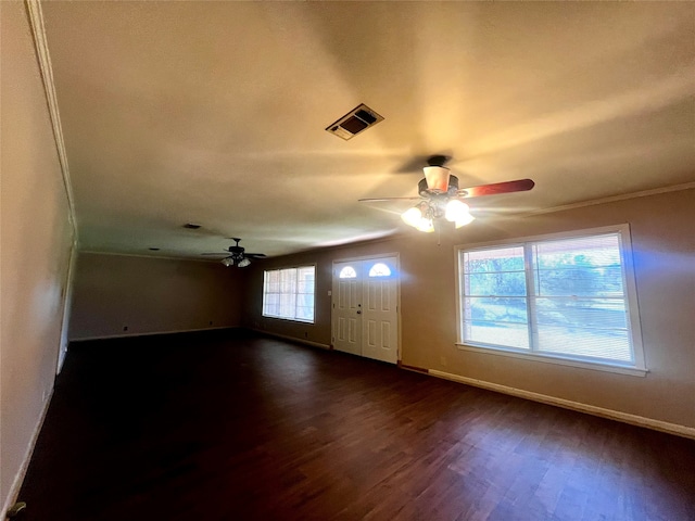 unfurnished room featuring crown molding, ceiling fan, and dark wood-type flooring