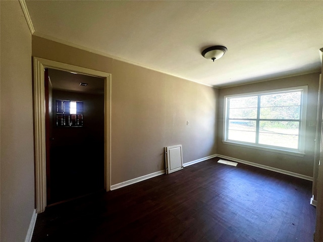 unfurnished room with dark hardwood / wood-style floors and ornamental molding