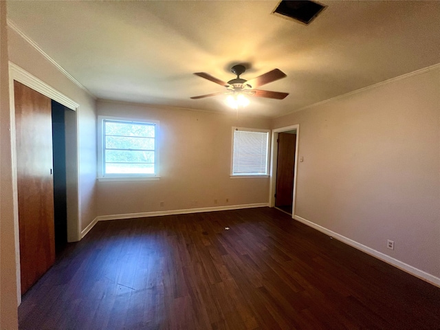 unfurnished bedroom with ceiling fan, dark wood-type flooring, and ornamental molding