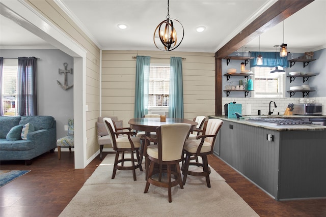 dining area featuring dark hardwood / wood-style floors, an inviting chandelier, and a wealth of natural light