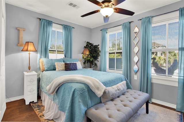 bedroom with ceiling fan and dark hardwood / wood-style flooring