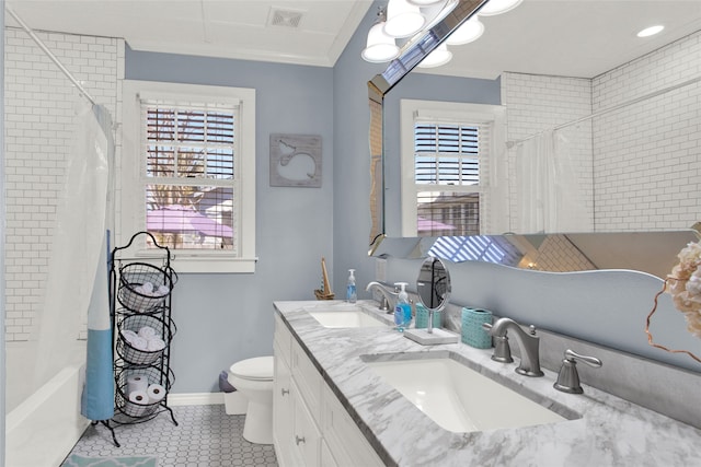 full bathroom with plenty of natural light, shower / bathtub combination with curtain, toilet, and dual bowl vanity