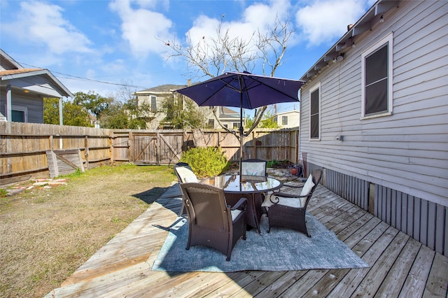 deck featuring a lawn and a patio