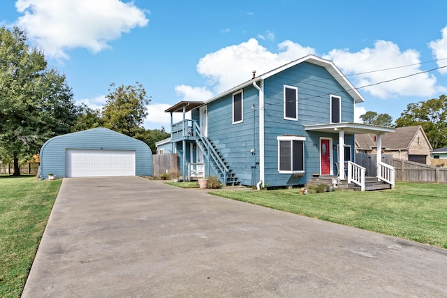 front facade with a front lawn, an outdoor structure, and a garage