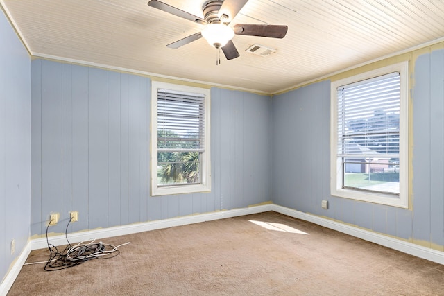 empty room with carpet, ornamental molding, and ceiling fan