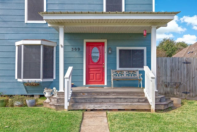 entrance to property with a lawn