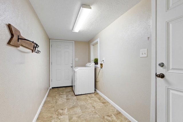 washroom featuring light tile floors, a textured ceiling, and washer / dryer