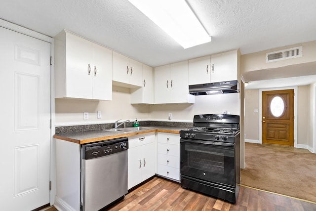 kitchen with light colored carpet, sink, white cabinets, black gas stove, and stainless steel dishwasher